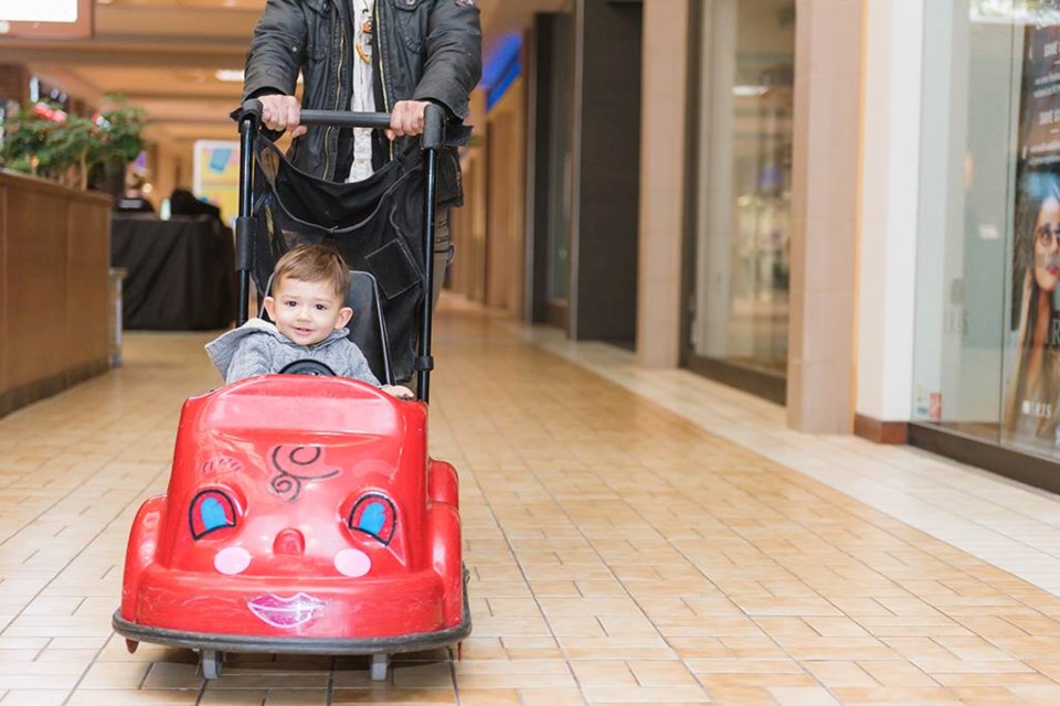 A parent pushing her child in a kid's cart at the Pine Centre Mall in Prince George (via Facebook/Pine Centre Mall)