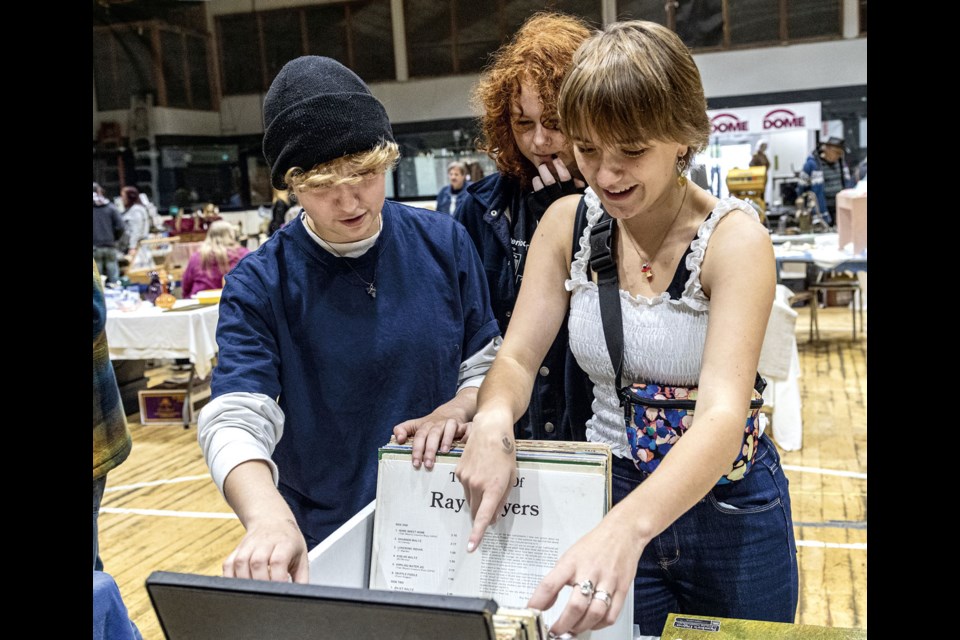 Kate Green, 16, (left), Bree White, 14, and Lily Watchell, 15, search through a collection of old LP records Saturday while visiting the 32nd Annual Antiques and Collectibles Fair at the Roll-A-Dome. The fair has been held to raise funds for the South Bowl Community Association for scholarships and recreational programs in the Peden Hill, Van Bien, Westwood and Pinewood areas.