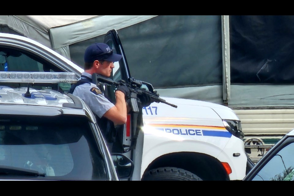 Prince George RCMP officers surround a home on Cuddie Crescent on the afternoon of Saturday, Sept. 28, 2024