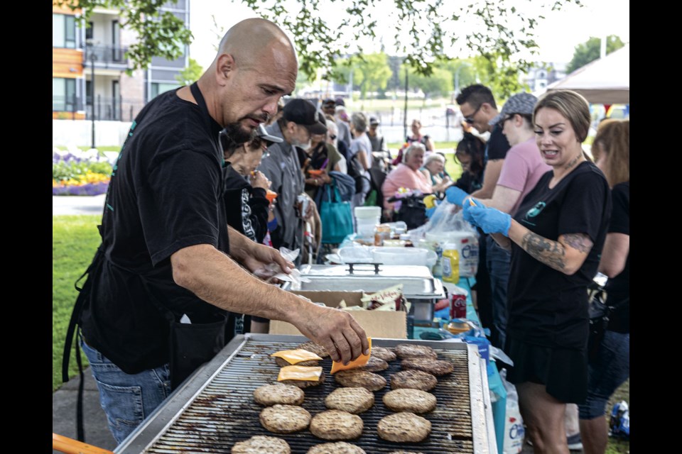 Daniel Gerow, an Olive Branch member, barbecues burgers for the AWAC 30th Anniversary and the Third Annual Mark DeSouza Memorial Picnic at Veterans Plaza in front of City Hall on Saturday afternoon.