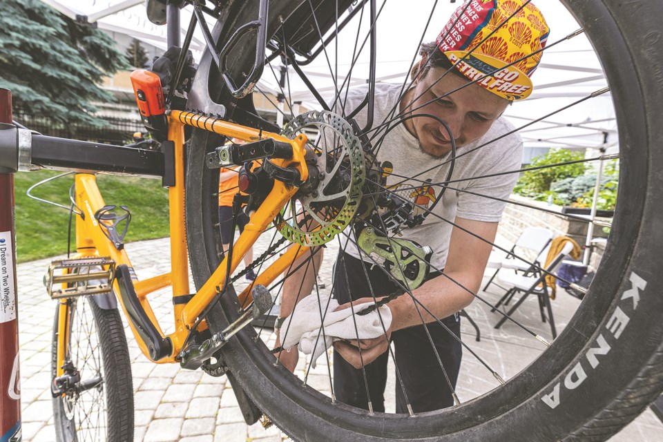 Nick Dormaar works on adjusting a bike he is working on during the Bike Repair Cafe at the Prince George Public Library in the Knowledge Garden Saturday afternoon. 