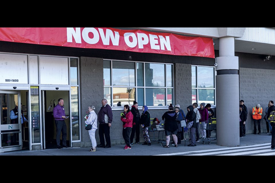 Shoppers lined up prior to the 8AM opening of the new Buy Low Foods at Parkwood Mall Saturday for a chance to receive a $10 discount card for the first 100 customers, as well as Spin and Win giveaways in store.