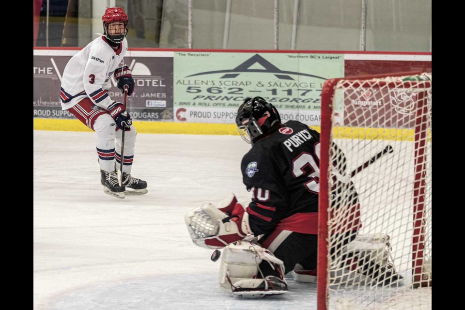 Cariboo Cougars U15 goalie Brennen Purych stops a shot from Greater Vancouver Canadians U15 #3 Boden Spratley during Friday's 5-3 loss at Kin 1.