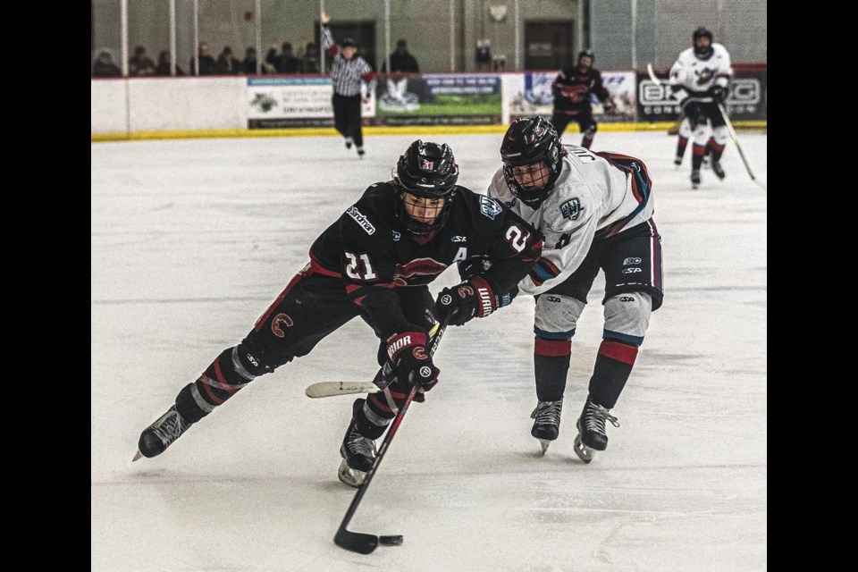 Rockets forward Nathan Juch tries to stop Cariboo Cougars forward Rylan Bissett from turning in toward the goal Friday, March 21, 2025 at Kin 1.