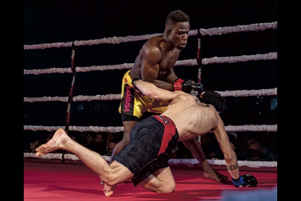 Edwin Ssekibuule takes Arturo Sulbaran Pena to the mat after connecting with a punch during their 125 pound bout Saturday during Champions of the North at the Roll-A-Dome.