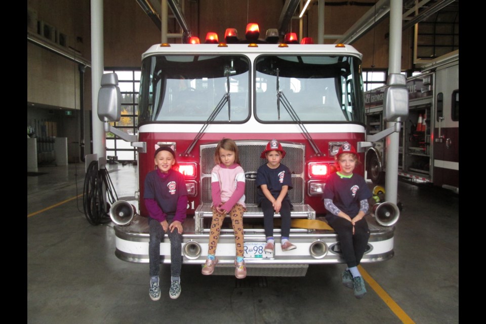 Four local children, from left, Julia Beckett, Smith Cleverley, Addison Parker and Jonah Tajcnar won a contest to be junior fire chiefs for a day.