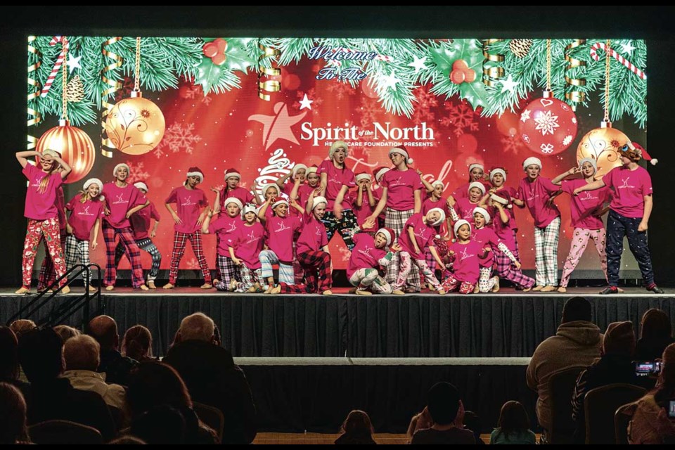 Performers from Judy Russell's Enchainement Dance Centre perform "I Don't Know What Christmas Is" on stage during the Festival of Trees at the Civic Centre as the Civic Light Up events unfold outside Thursday.