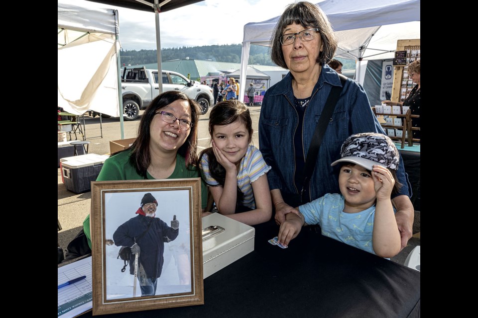 Susan Chin, her daughter Leanne and grandkids accept donations to the Chuck Chin Legacy Fund in honour of acclaimed photographer and community booster Chuck Chin at the CN Centre Night Market Tuesday. Donations can be made through the Prince George Community Foundation with cheques having a memo showing the Chuck Chin Legacy Fund or directly though the website bit.ly/chuckchinlegacy.