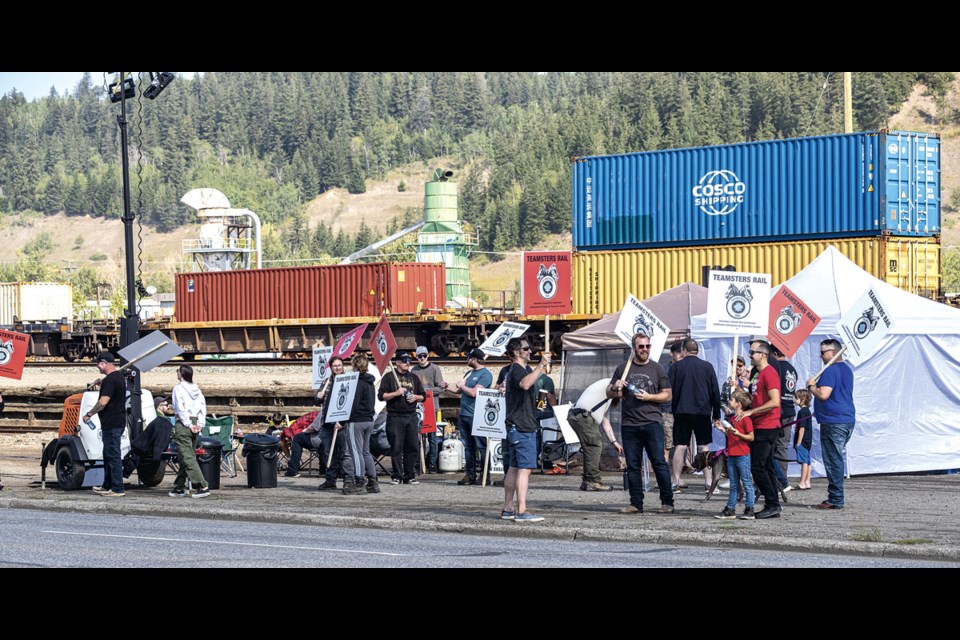 CN Rail workers protest their lockout along the CN Yard on First Avenue Thursday morning.