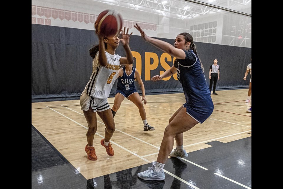 CHSS #5 Olivia Young forces DPSS #8 Mercedes Black to pass around her during the senior girls final of the Condor Classic Friday.