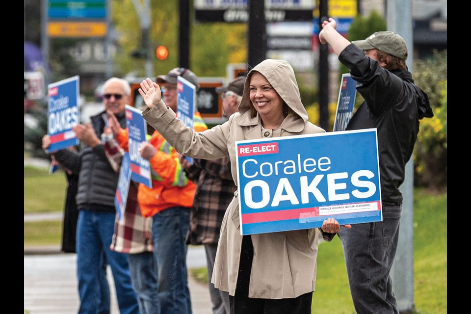 Coralee Oakes waves to passersby as she is joined by her Prince George team to launch her campaign for re-election in the Prince George-North Cariboo riding with a sign waving session at Domano Boulevard and Highway 16 West Saturday. 