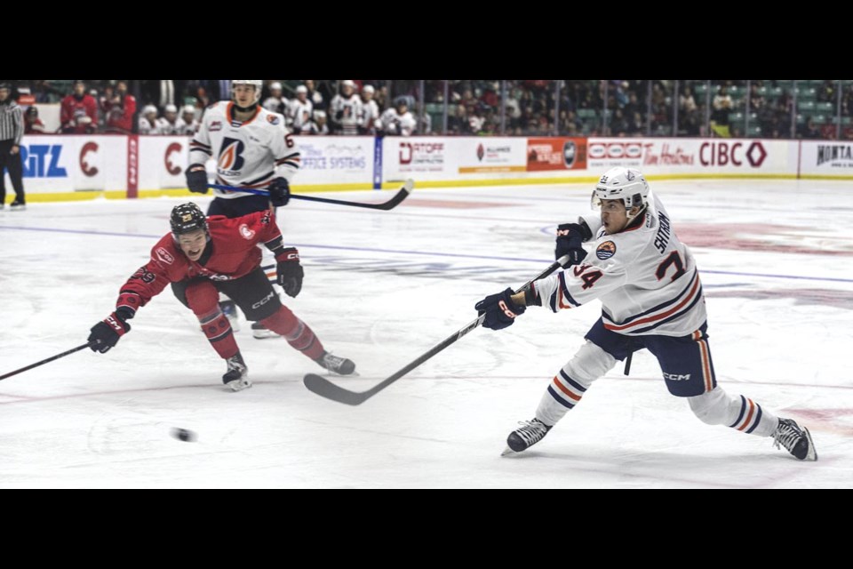 Blazers forward Oren Shtrom looses a shot while Cougar forward Matteo Dania attempts to block Saturday January 25 at CN Centre. Shtrom's shot found the back of the net to take the Blazers to a 5-2 lead in the third period.