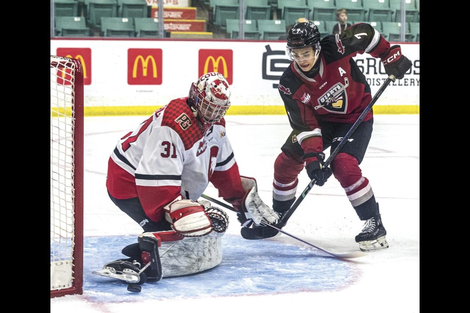 Giants forward Ty Halaburda's shot is turned aside by the pad of Cougars goalie Josh Ravensbergen Tuesday at CN Centre.