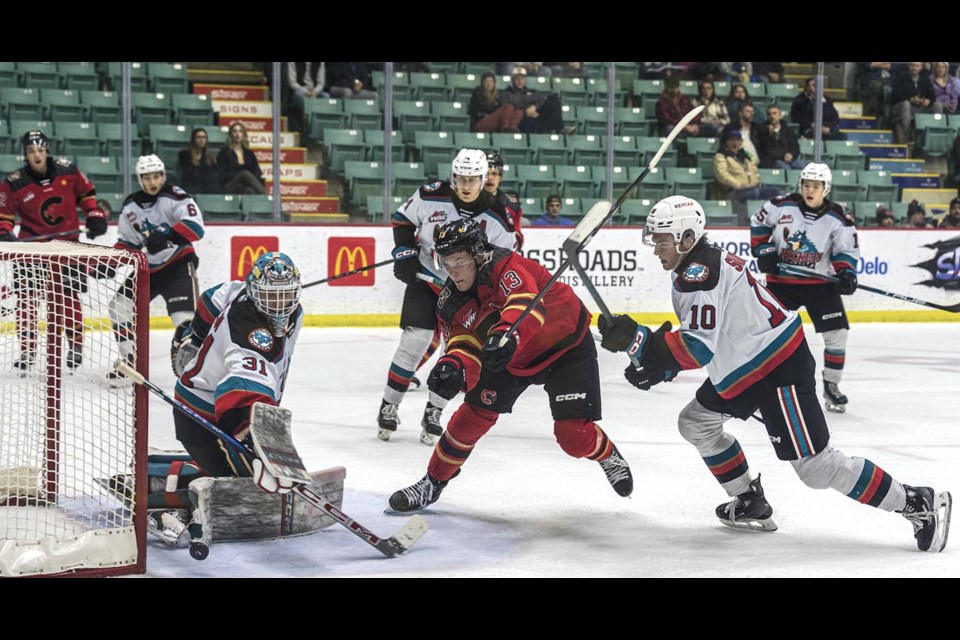 Rockets goalie Jake Pilon deflects the puck as Cougars forward Koehn Ziemmer rushes in for the rebound and Rockets defenseman Will Sharpe moves in to stop him Tuesday Feb. 25 at CN Centre.