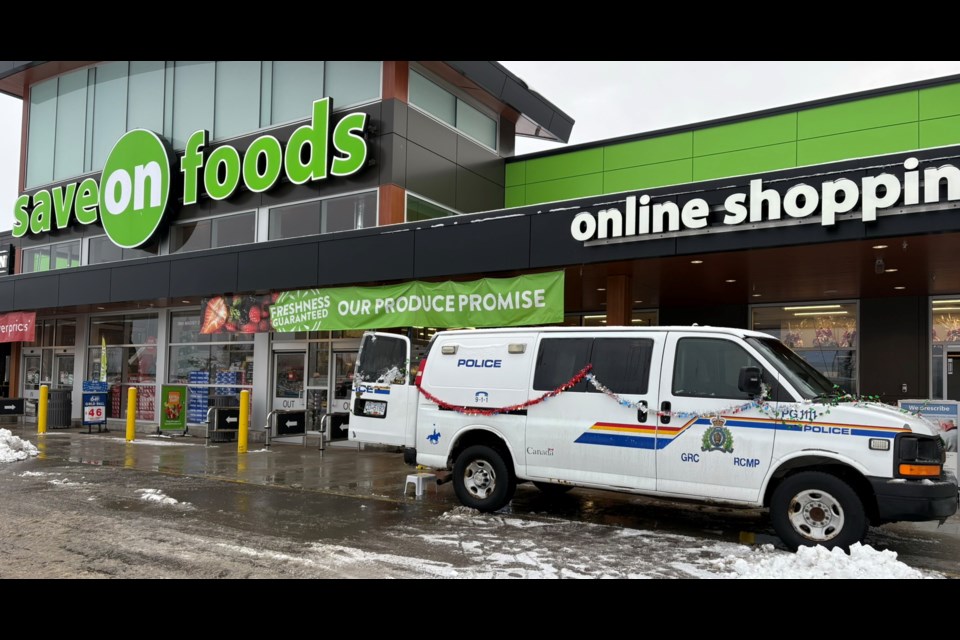 A police cruiser is parked outside the Pine Centre Save-On-Foods store on Saturday, Dec. 14, 2024 for the Prince George RCMP's annual Cram-A-Cruiser event.