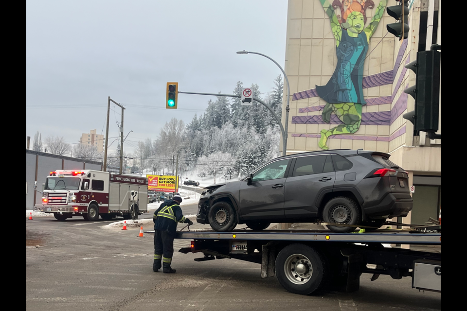 One of two vehicles involved in a collision at Queensway and 5th Avenue in Prince George, BC on Tuesday, Jan. 28, 2025 is loaded onto a truck.