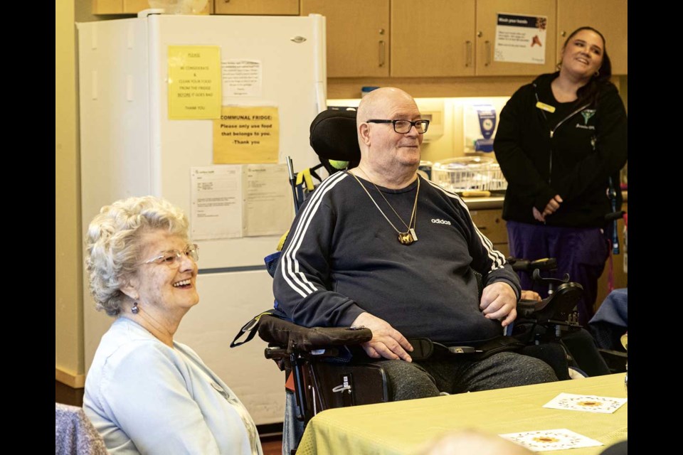 Gateway Lodge resident Darrell Wolfe and wife Gail enjoy the occasion on Monday, Oct. 21 as they celebrate Darrell's 15-year anniversary since arriving at the facility as part of the first residents to move in. Wolfe, who has been a quadriplegic since a four-wheeler accident 20 years ago, is the last of the initial group to still be at Gateway.