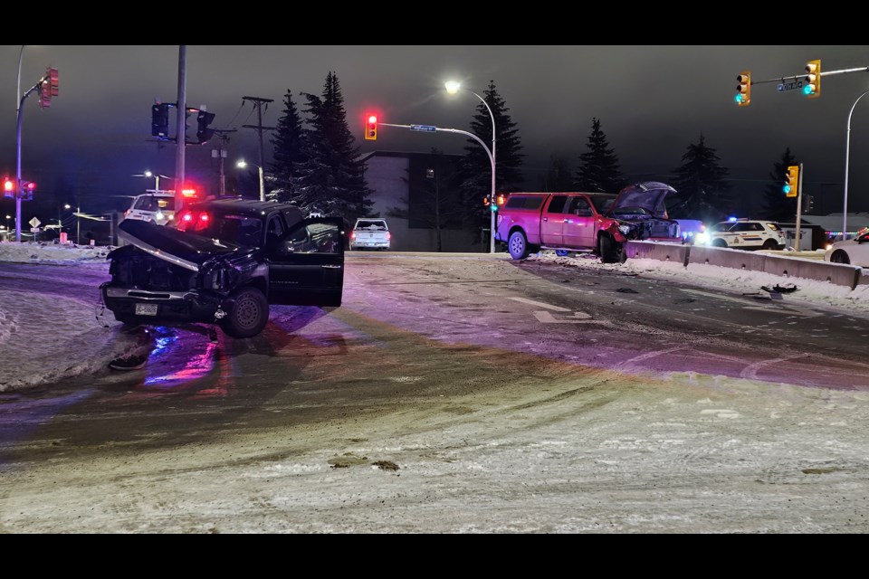 Prince George RCMP investigate at the scene of a two-vehicle collision at Highway 97 and 10th Avenue on Monday, Dec. 16 in Prince George, BC.