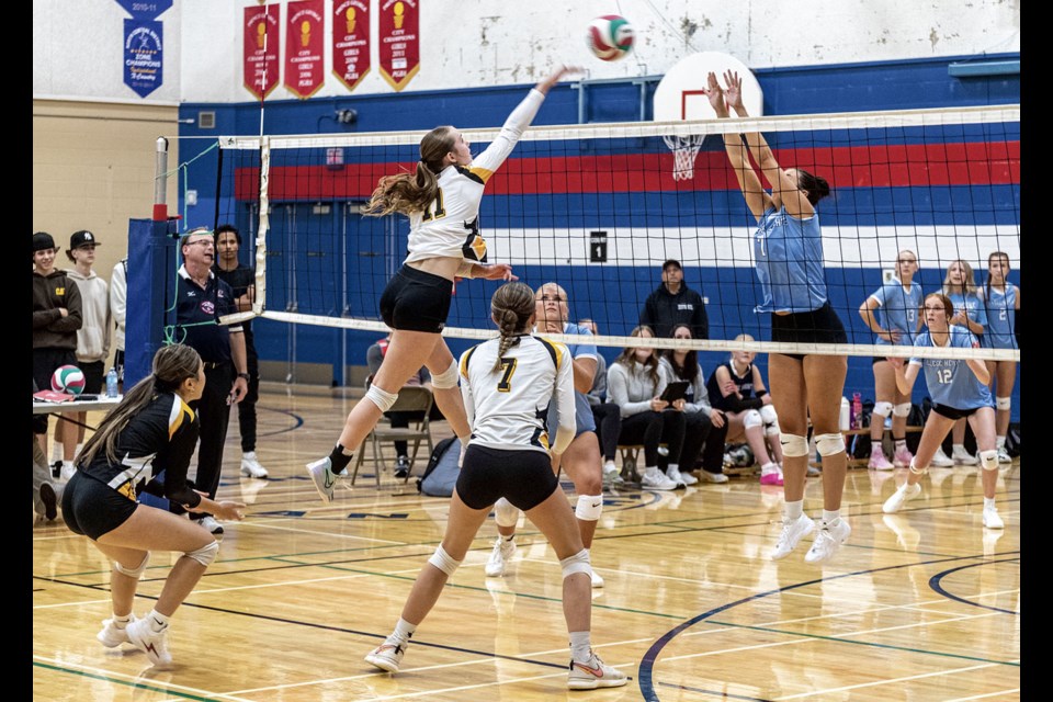 Alaina Goodlet of the CHHS Cougars jumps to block a spike by DPSS Condors Camryn Maclachlan during the girls final at the D.P. Todd Sr. Boys and Girls Tournament Saturday. CHSS defeated DPSS in three sets to win the tournament.