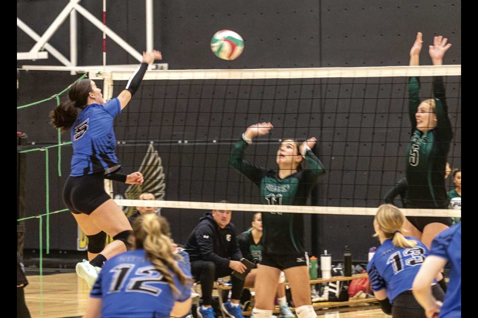 Correlieu Coyote Ashley Burke fires a spike over the net at PGSS Polars Olivia Amar and Jocelyn Murguly in a match Friday, Oct. 25 during the Duchess Park Senior Tournament.