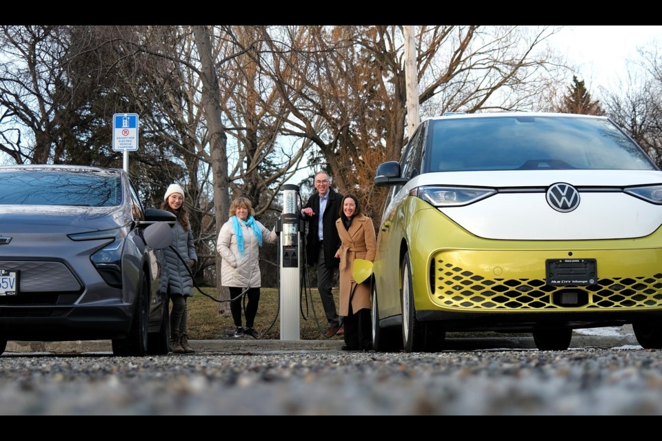 Community Energy Association staff gather at a Charge North station in Lheidli T'enneh Memorial Park in Prince George.