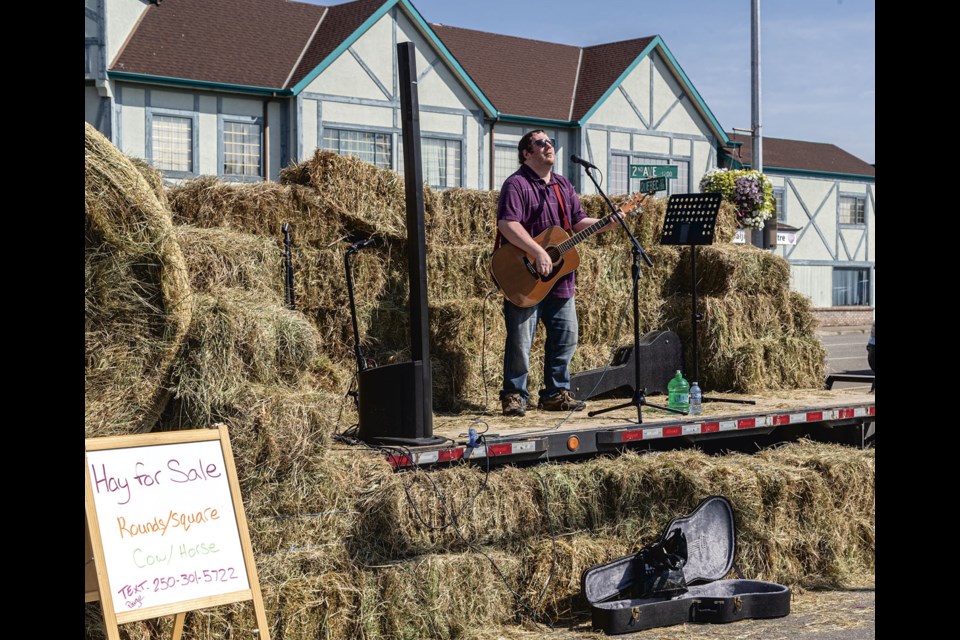 Local musician Scott Lapointe takes to the hay bale stage to entertain the crowds at the Prince George Farmer's Market Saturday. Vendors had the roads blocked off from Second Avenue to Third Avenue on Quebec Street and between Quebec and Dominion Streets selling everything from apples to water.