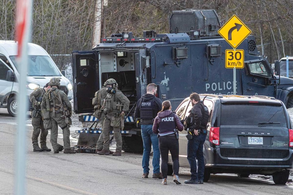 RCMP Emergency Response Team members stash their equipment following a raid on a home at 4102 First Ave. Monday, Feb. 24, 2025 in Prince George, BC.