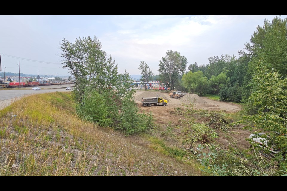 Crews work at a city-owned property near the corner of 1st Avenue and Carney Street on Thursday, Aug. 15, 2024 in Prince George, B.C. The lot will be used to store gravel.