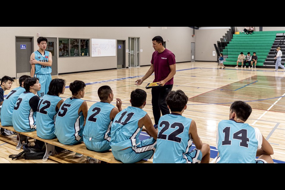 Former Duchess Park Condor Nathan Yu addresses his U16 Triple Double Basketball Academy U-16 boys team from Hong Kong during their exhibition game Monday at Cedars Christian School against Northern Bounce Academy.