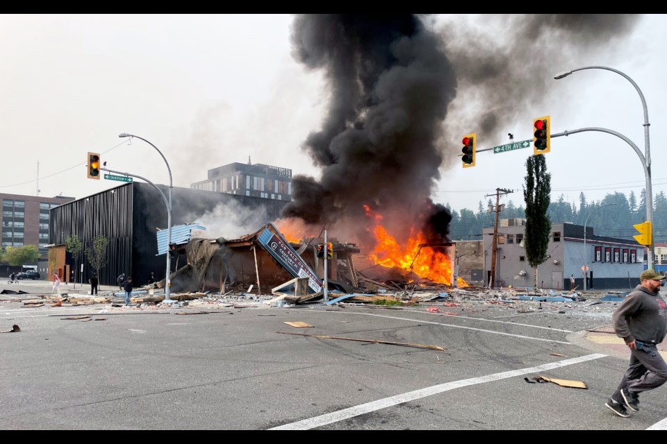 A man runs from the scene of Tuesday's explosion in downtown Prince George.