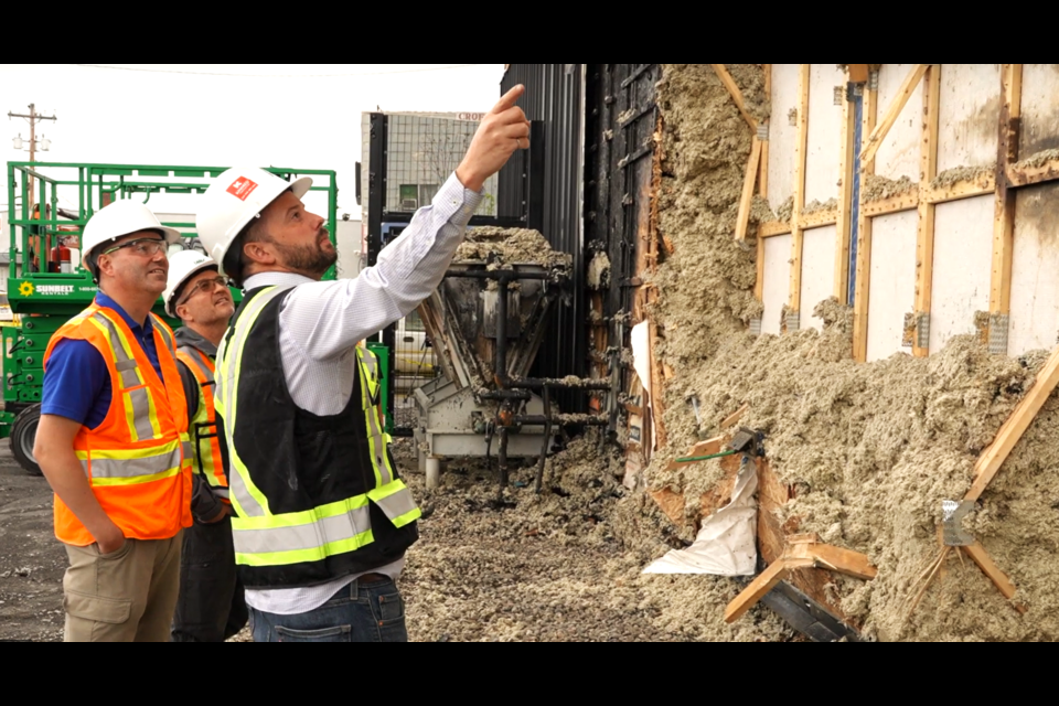 Engineers survey the damage caused by the Achillion Restaurant explosion to the west wall of UNBC's Wood Innovation Research Laboratory. 