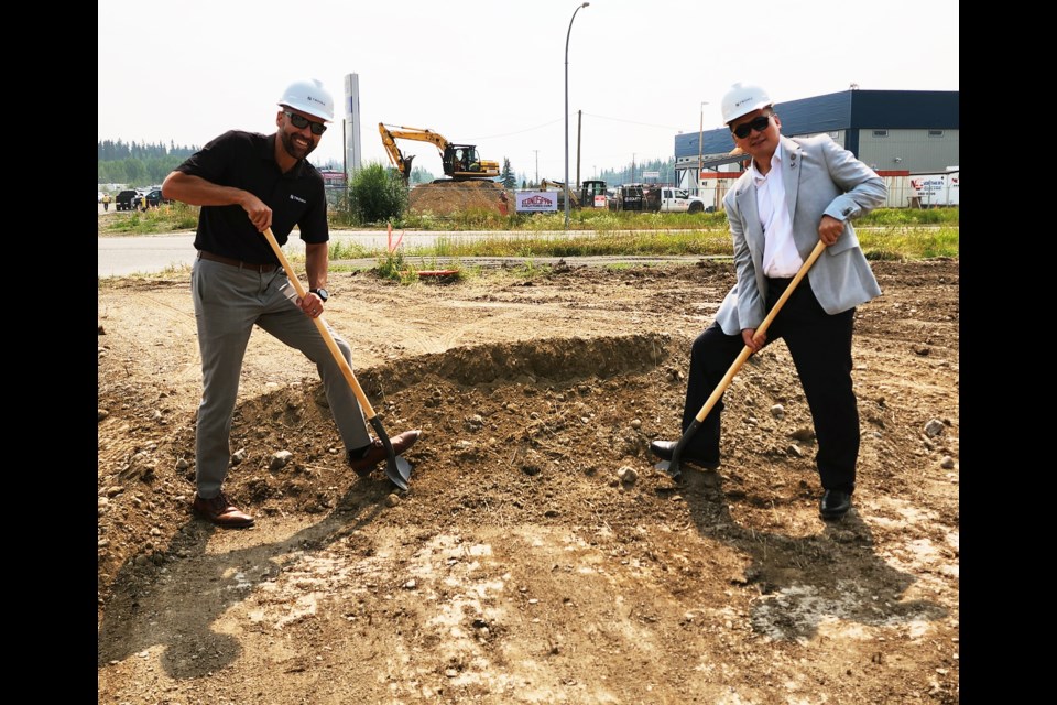 Rich Threlfall of Troika Management and Prince George Mayor Simon Yu break ground on the Caribou Crossing development along Boundary Road.