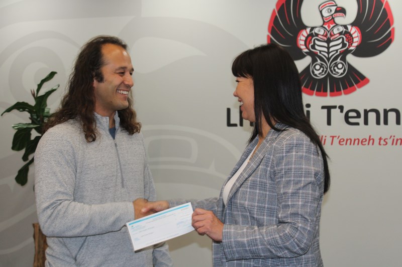 MSS president James Hiebert presents a $15,000 cheque to Lheildi T'enneh Chief Dolleen Logan. 