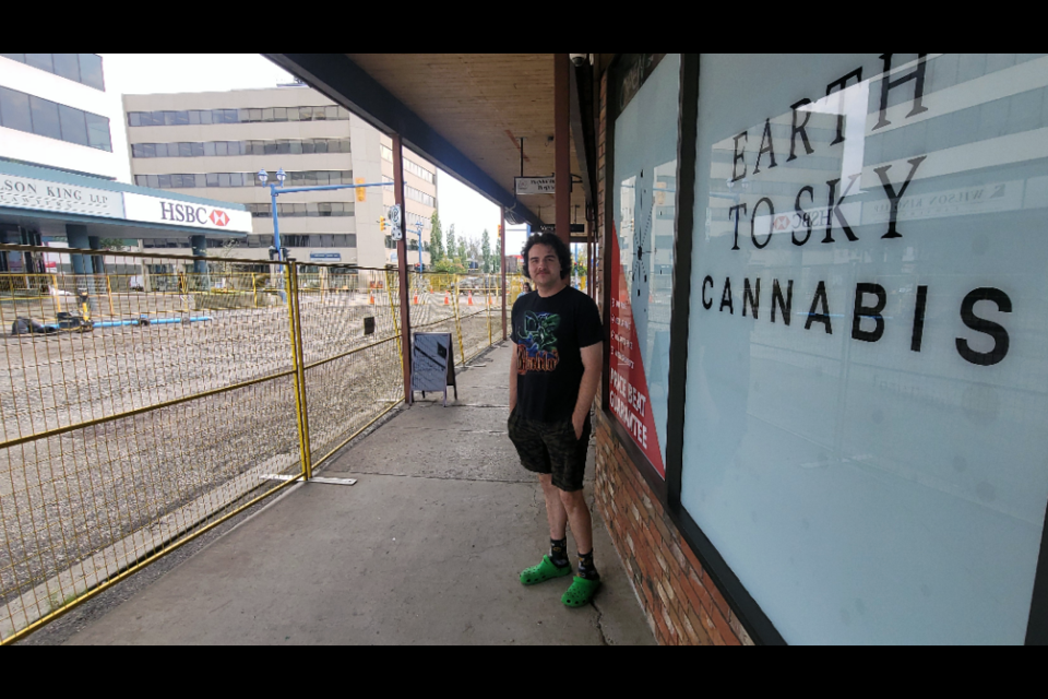 Garnet Grenon looks out at the watermain construction project that has closed Third Avenue in front of his Earth To Sky Cannabis store