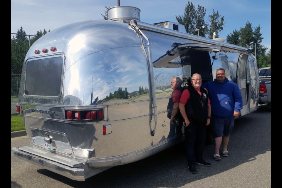 Rick and Ryan Cyre, co-owners of White Goose Bistro, show off their polished aluminum trailer they've equipped to bring hot food items from their restaurant to remote locations at events around city.