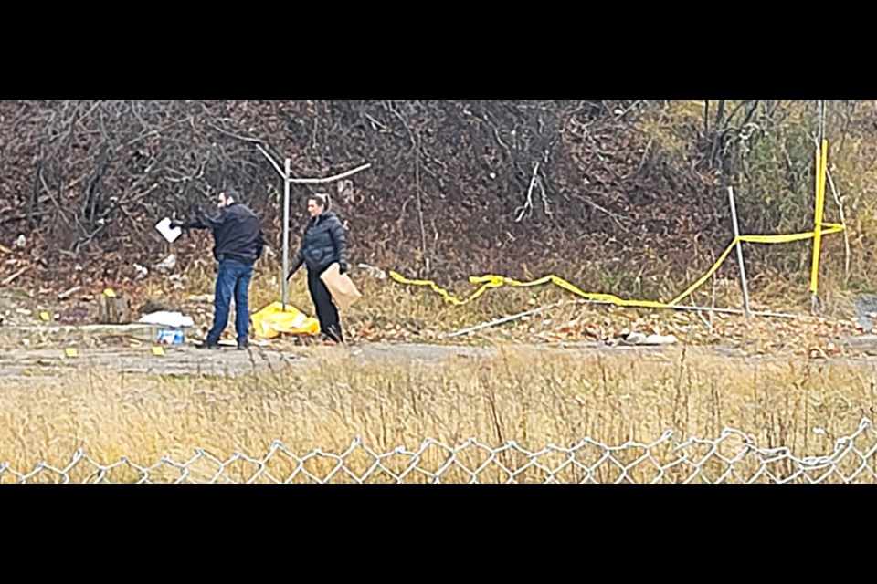 RCMP crime investigators sift through evidence at the scene of an apparent homicide in a vacant lot across from the Victoria Medical Building off Victoria Street.