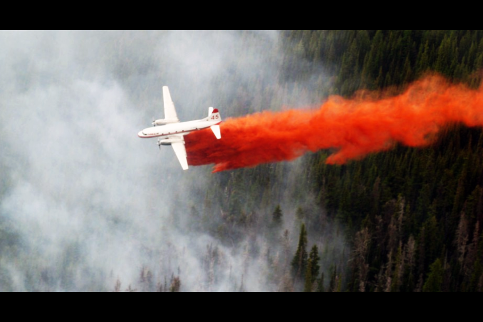 A Conair Aerial Firefighting tanker dumps fire retardant on a fire in B.C. The Abbotsford-based company has several aircraft using Prince George Airport as a staging area.