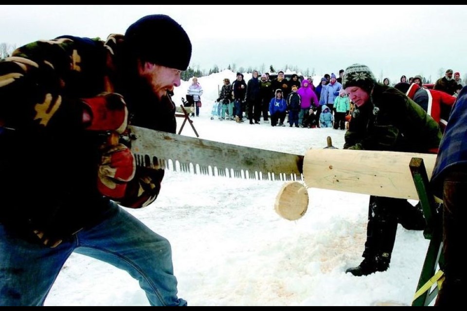 Tron Rouleau, left, and Jeff Parish finish their cut in the team crosscut event in 2011 at the Pineview Snow Frolics.