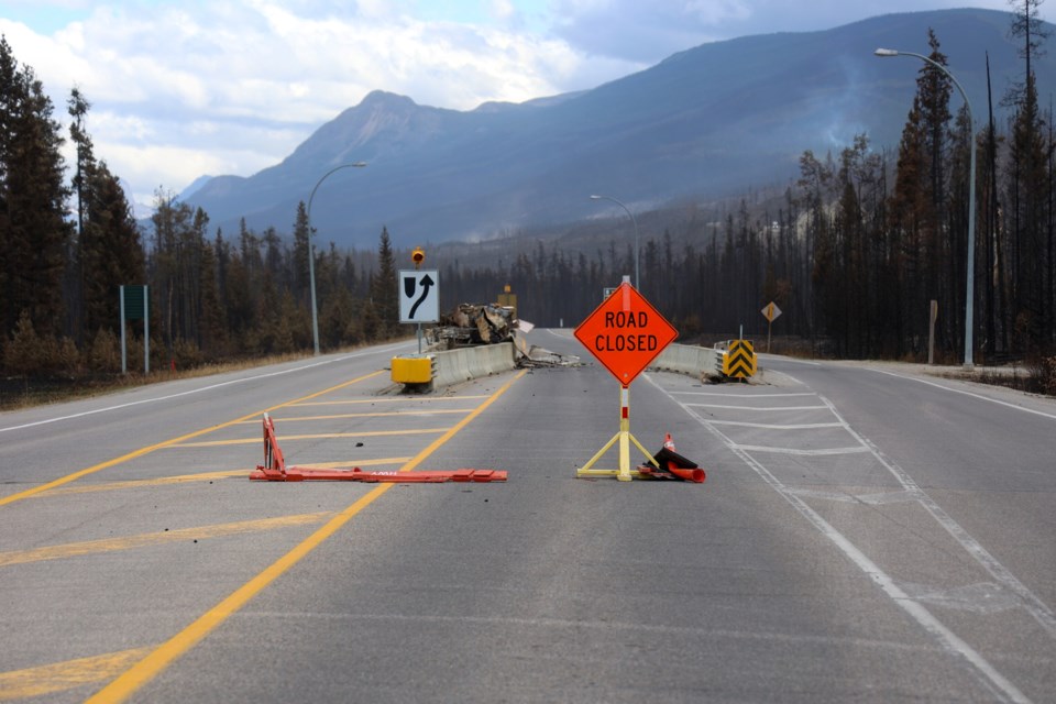 The road to Jasper along Highway 16 remains closed but commercial trucks will be allowed through during certain times of the day.