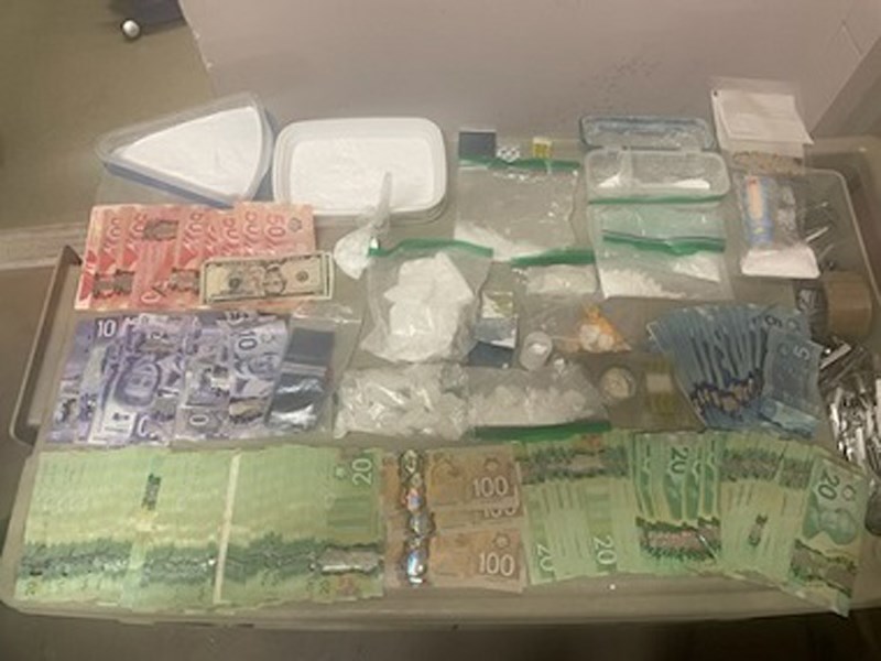 Police located suspected cocaine and  methamphetamine, a large sum of cash, paraphernalia often used in drug trafficking, one firearm and numerous edged weapons.