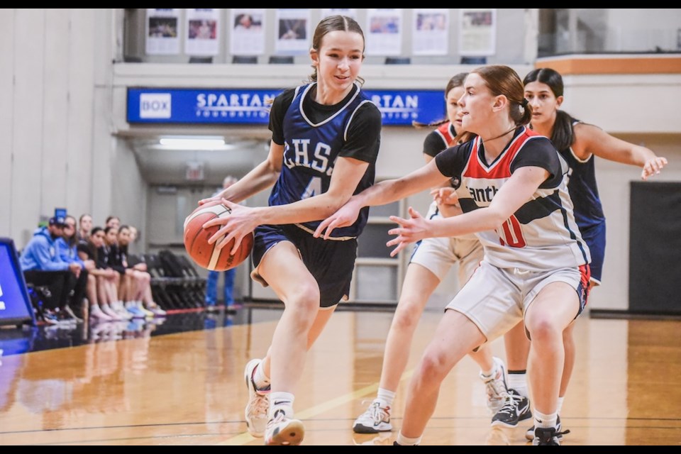 College Heights Cougars' Kayleigh Kennedy (left) tries to avoid Vernon Panthers defender Charlotte Routley during quarterfinal action at the 2025 B.C. senior girls triple-A basketball championships Thursday, Feb. 27, 2025 at Langley Events Centre. 