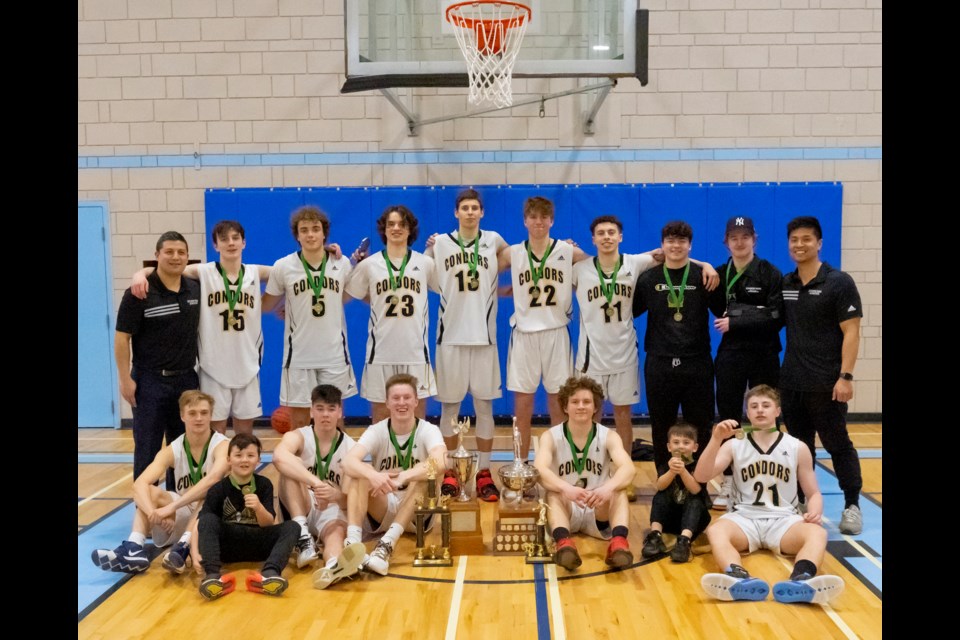 The Duhess Park Condors pose with their prize - the North Central zone triple-A boys basketball championship trophy Saturday in Quesnel.