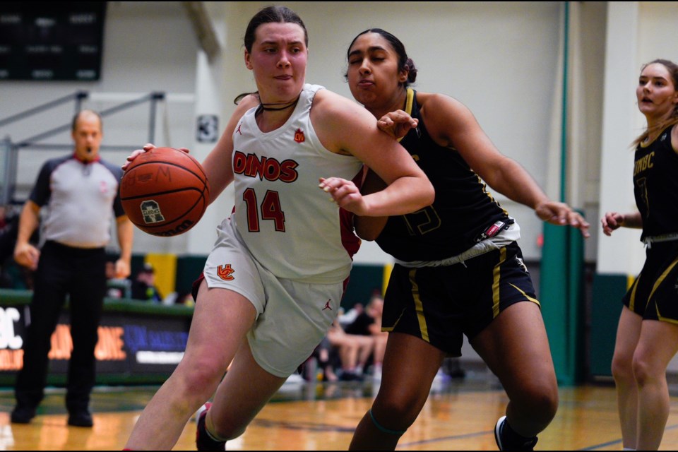 Calgary Dinos guard Madison Landry moves the ball into scoring range while avoiding the check of UNBC Timberwolves defender Amrit Manak, during their game Nov. 27 at the Northern Sport Centre.