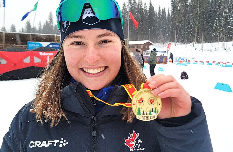 Caledonia Nordic Ski Club member Moira Green of Prince George holds up the gold medal she won Saturday in the junior women's sprint race at the Biathlon Canada Junior/Youth World Championship trials. The event continues Sunday with the pursuits and Tuesday with mass start races.