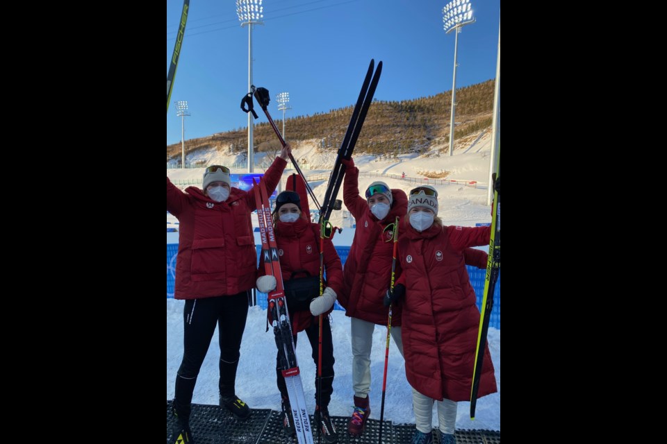 The Canadian women's biathlon relay team celebrates its 10th place finish Wednesday at the Beijing Olympics. From left are Sarah Beaudry, Emily Dickson, Megan Bankes and Emma Lunder.