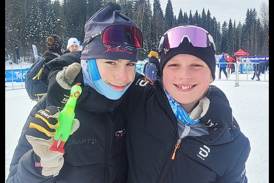 Victor Lafontaine of Gatineau, Que., left, holds the exchange trip mascot, Bawk the Chicken, while standing next to Scott Moore of the host Caledonia Nordic Ski Club. The two 14-year-olds raced over the weekend in the Teck BC Cup cross-country ski events at Otway Nordic Centre.