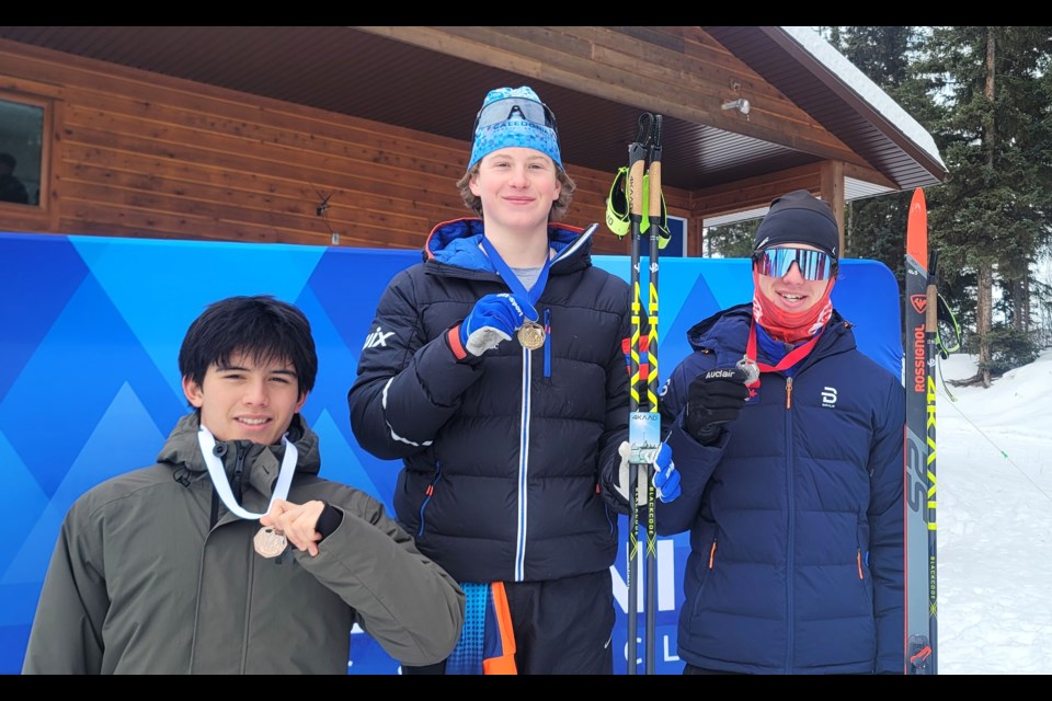 Tanner McConkey of the Caledonia Nordic Ski Club (centre) stands tall on the medal podium at Otway Nordic Centre after he won U18 men B-2 category in Sunday Teck BC Cup interval start freestyle race. Standing next to McConkey at right is silver medalist Axel Hostyn of Black Jack Ski CLub (Rossland) and at left is bronze medalist Lucas Gitt of Hollyburn Ski Club (Vancouver).