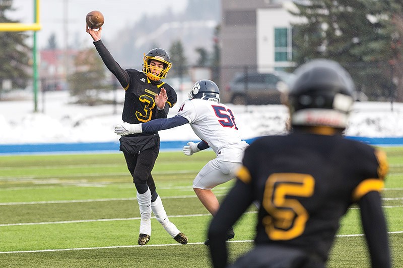 Citizen Photo by James Doyle. Duchess Park Condors quarterback Quinn Neukomm attempts a pass to receiver Carson Briere on Saturday morning at Masich Place Stadium in a B.C. Secondary Schools Football Association AA Varsity playoff game against the Vernon Secondary School Panthers.