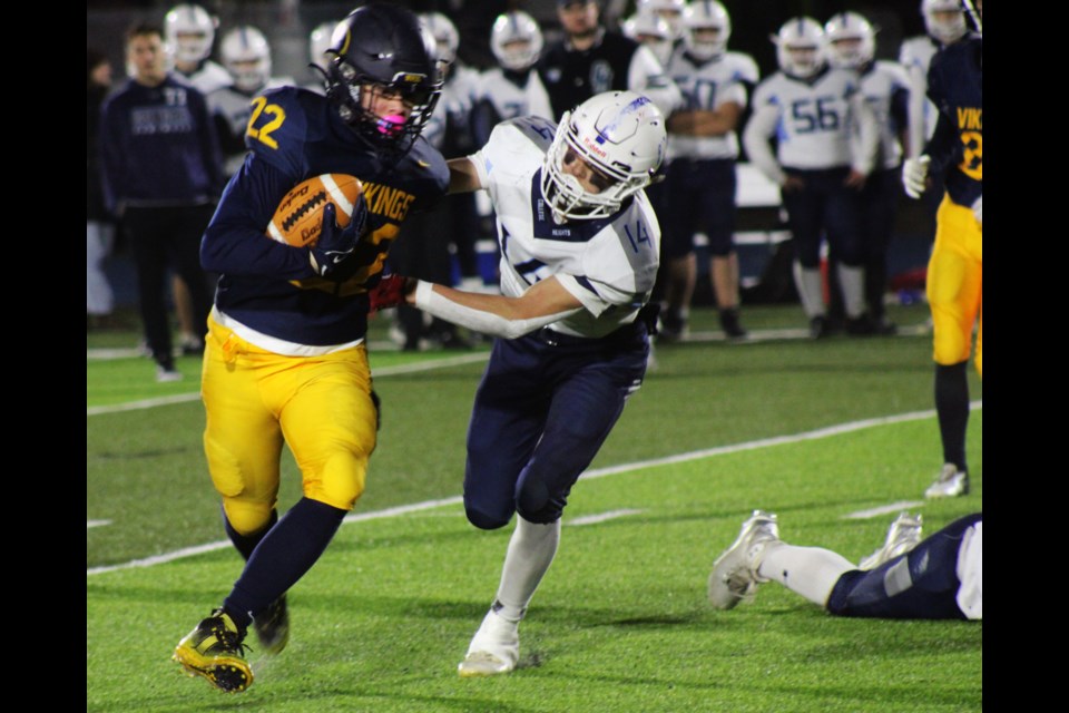 Nechako Valley Vikings running back Dexter Malo tries to elude College Heights Cougars tackler Decker Passey during Friday's P.G. Bowl high school football final at Masich Place Stadium.