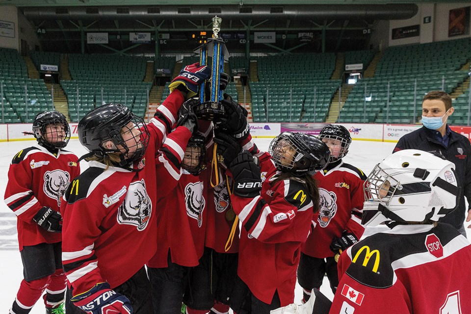 Citizen Photo by James Doyle. The Vanderhoof Bears celebrate with their trophy after winning the 19th Annual Shane Davis U11 Tier 1 Memorial hockey tournament on Sunday morning at CN Centre.